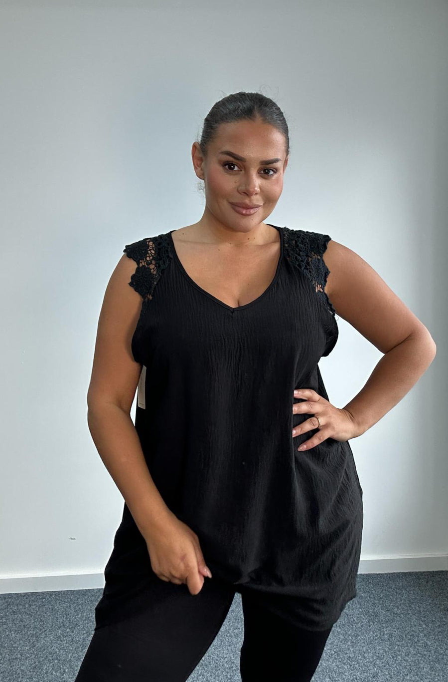 Woman in Black Plus Size Sleeveless Top with Lace Shoulder Detail