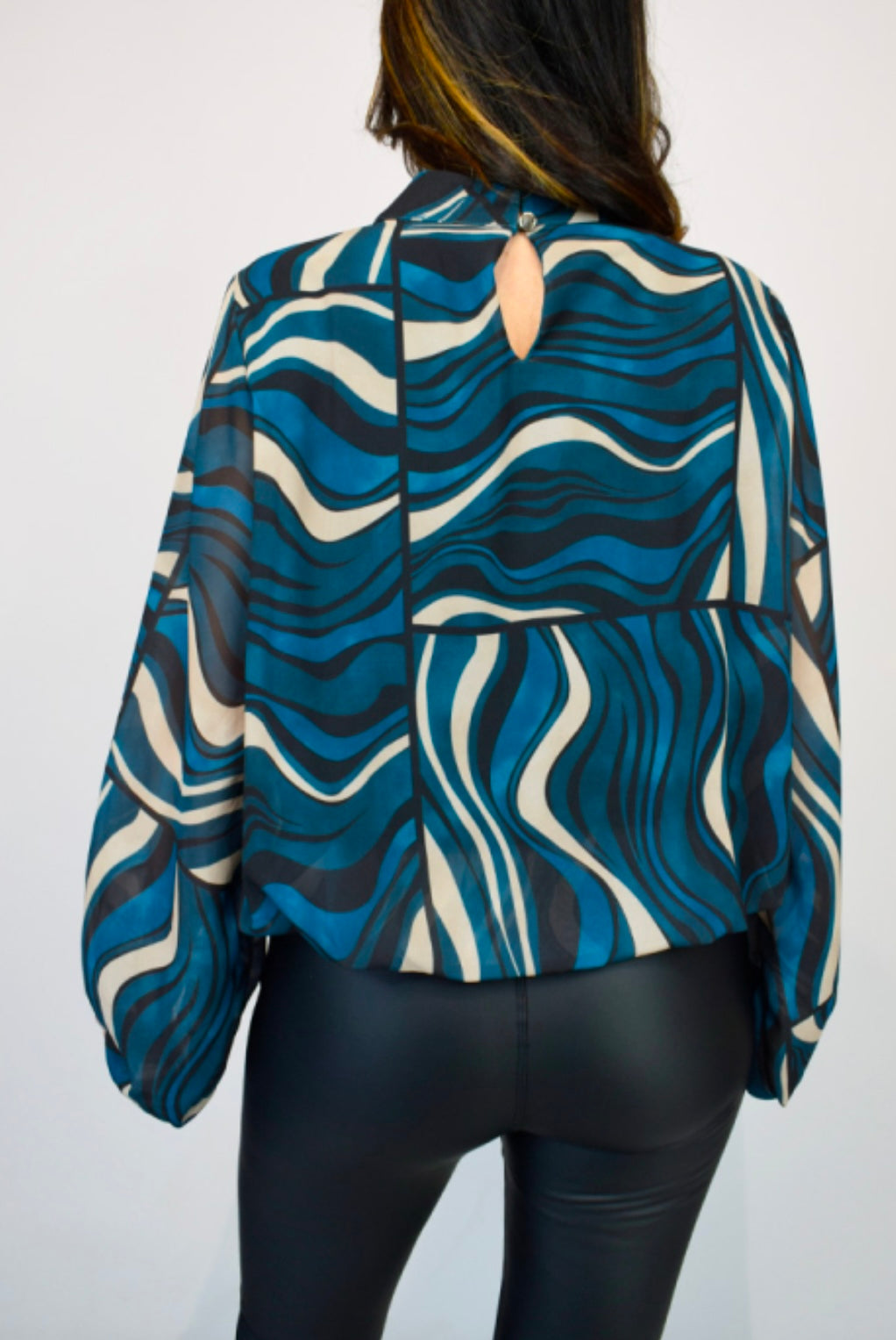 Back view of woman wearing a blue Geometric Volume Sleeve Italian Chiffon Blouse