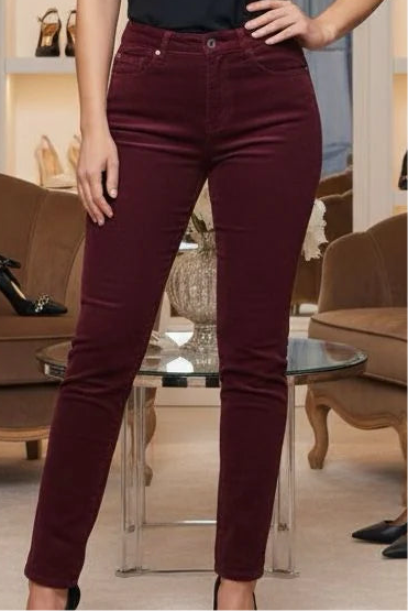 Close Up of Woman wearing burgundy wine Voggo Push Up Slim Fit Leg Jeans in a store setting with shoes and clothing in the background
