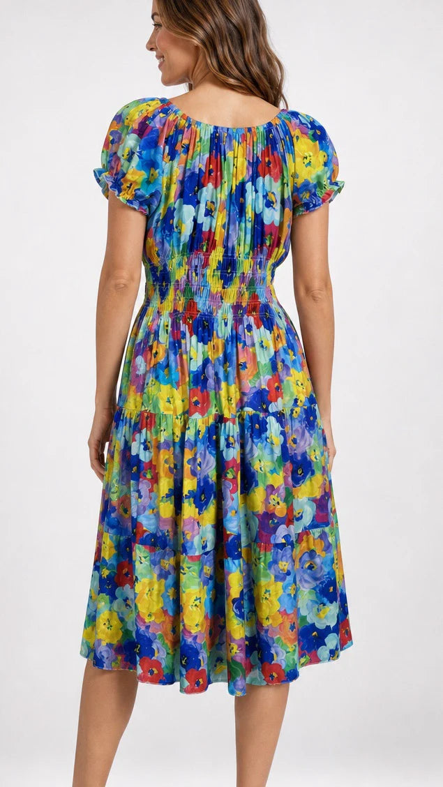 Back view of Woman wearing a colorful floral dress on a white background