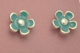 Pair of green flower-shaped earrings on a pink background