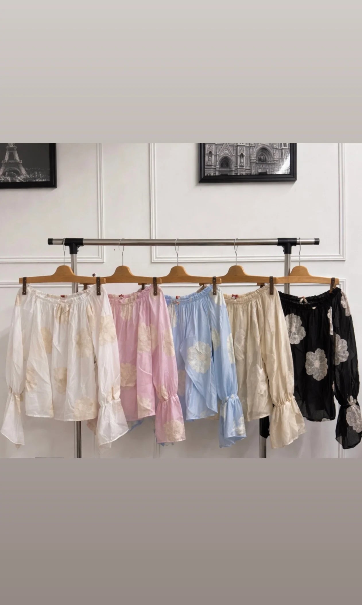 Collection of women's Luna Embroidered Flower Bardot Top displayed on a rack against a neutral background.