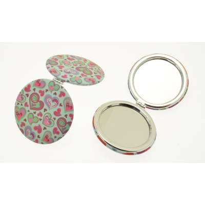 Compact mirror with heart design, on a white background.
