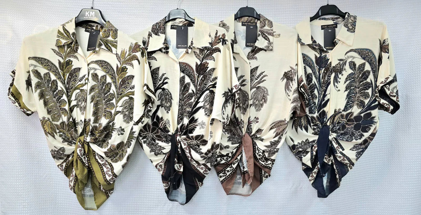 Four floral-patterned blouses on hangers against a white background
