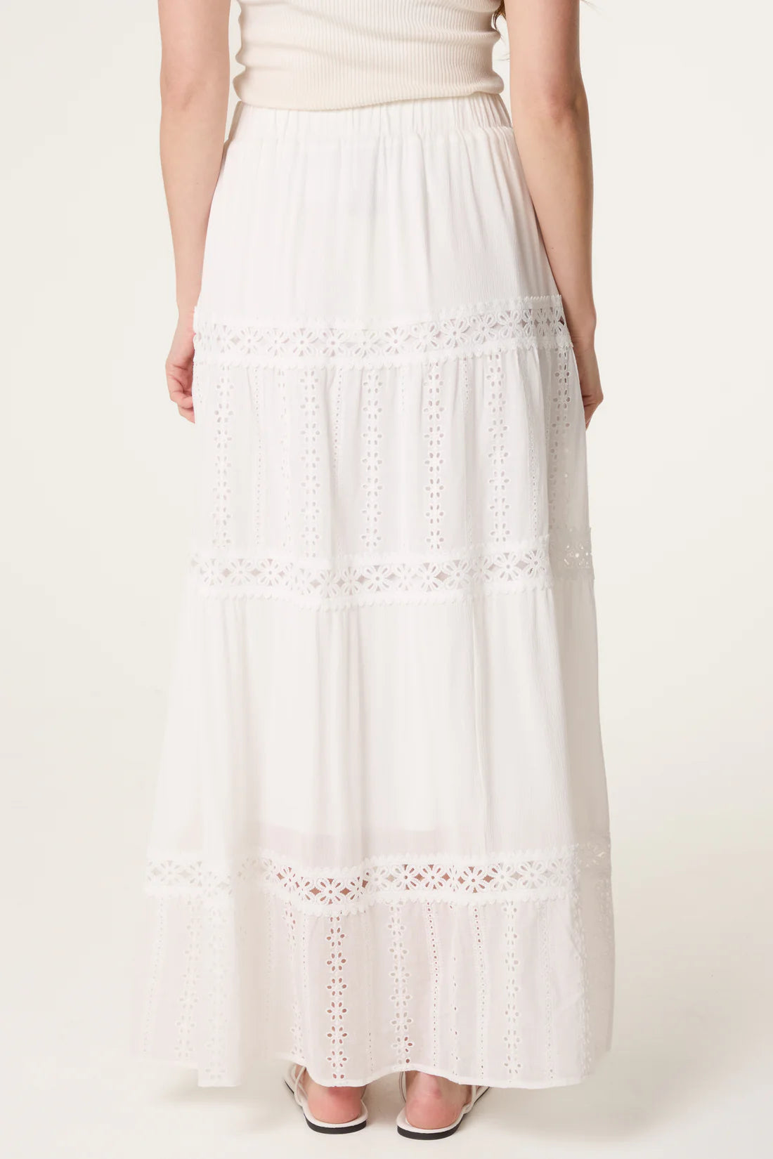 Rear view of White Broderie Anglaise Tiered Maxi Skirt worn by a person on a white background