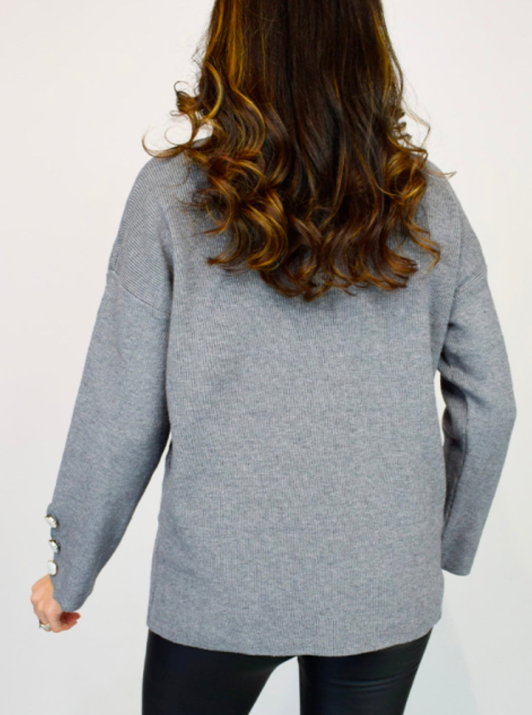 Woman wearing Button Cuff Oversize Roll Neck Grey Jumper. Back View