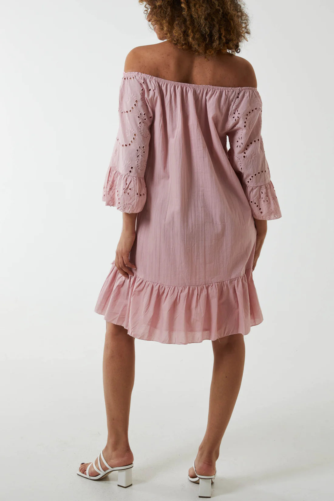 Woman wearing Pink Broderie Anglaise Bardot Dress. Back View.