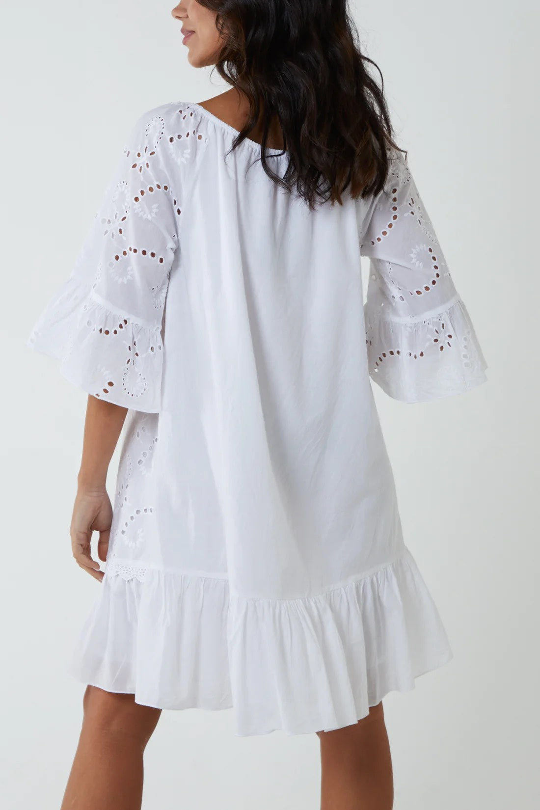 Woman wearing White Broderie Anglaise Bardot Dress. Back View