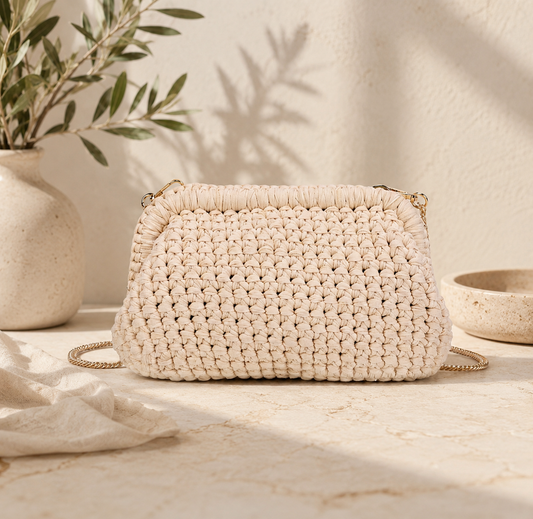 Woven handbag on a marble surface with a neutral background