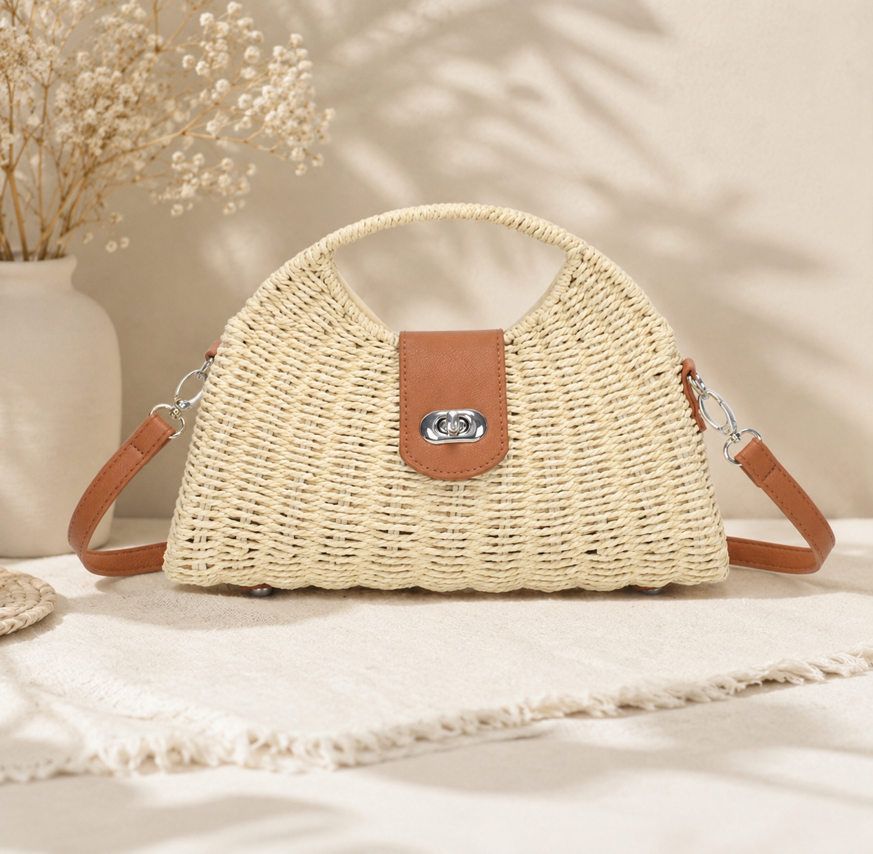 Woven handbag with brown accents on a light surface with a soft background