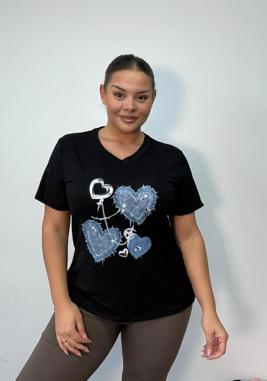 Woman wearing a Black Plus Size Denim Heart
Graphic Oversized T-Shirt on a plain background
