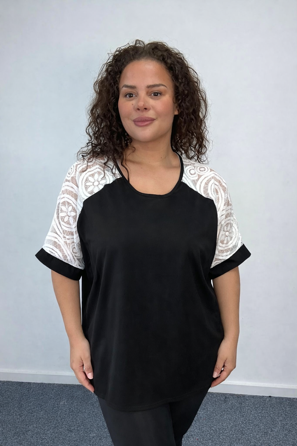 Woman wearing black Plus Size Lace Sleeve Oversized Top
