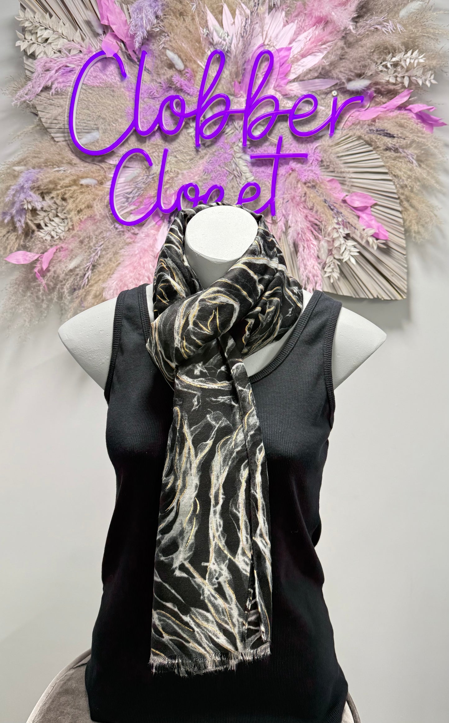 Mannequin wearing a black scarf with white patterns against a neutral background, with 'Clobber Closet' text.