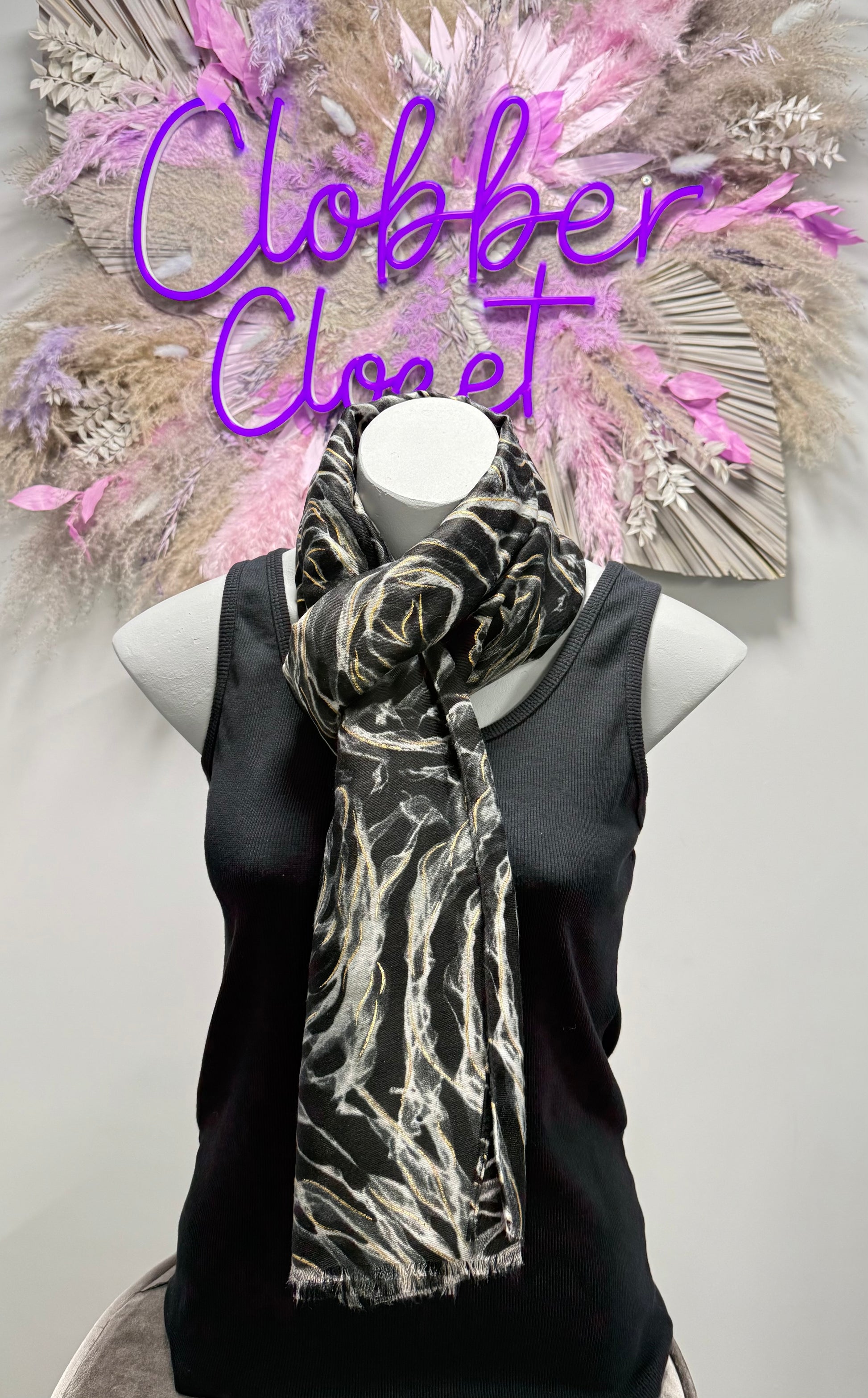 Mannequin wearing a black scarf with white patterns against a neutral background, with 'Clobber Closet' text.