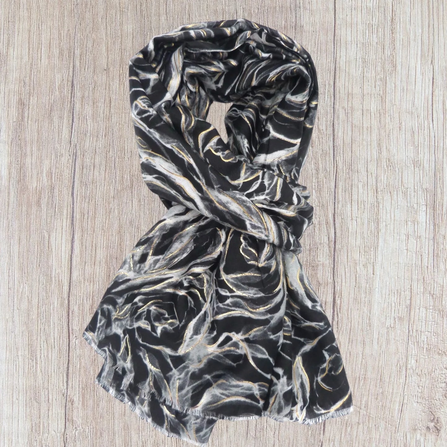 Black and white patterned scarf on a wooden surface