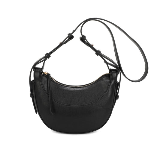 A black leather crescent-shaped shoulder bag with a long adjustable strap, gold-tone zipper, and small hanging leather charms, shown on a plain white background.
