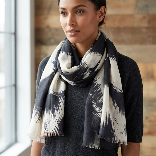 Woman wearing a Black and White Art Brush Print patterned scarf indoors