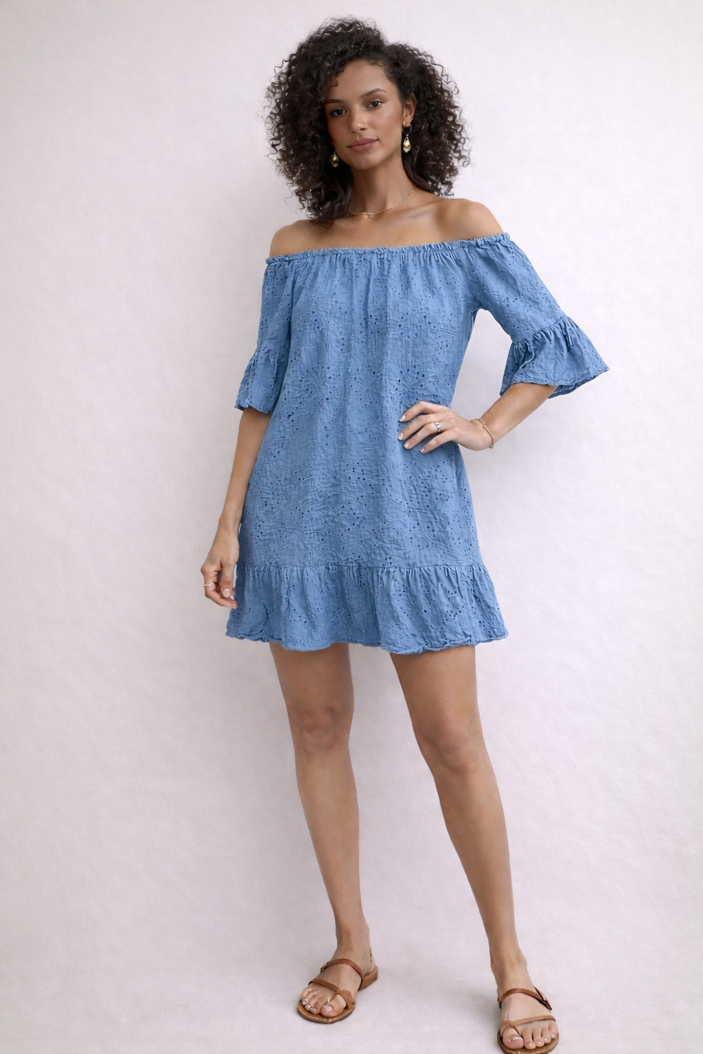 Woman wearing a Blue Italian Broderie Anglaise Dress/Top dress against a white background