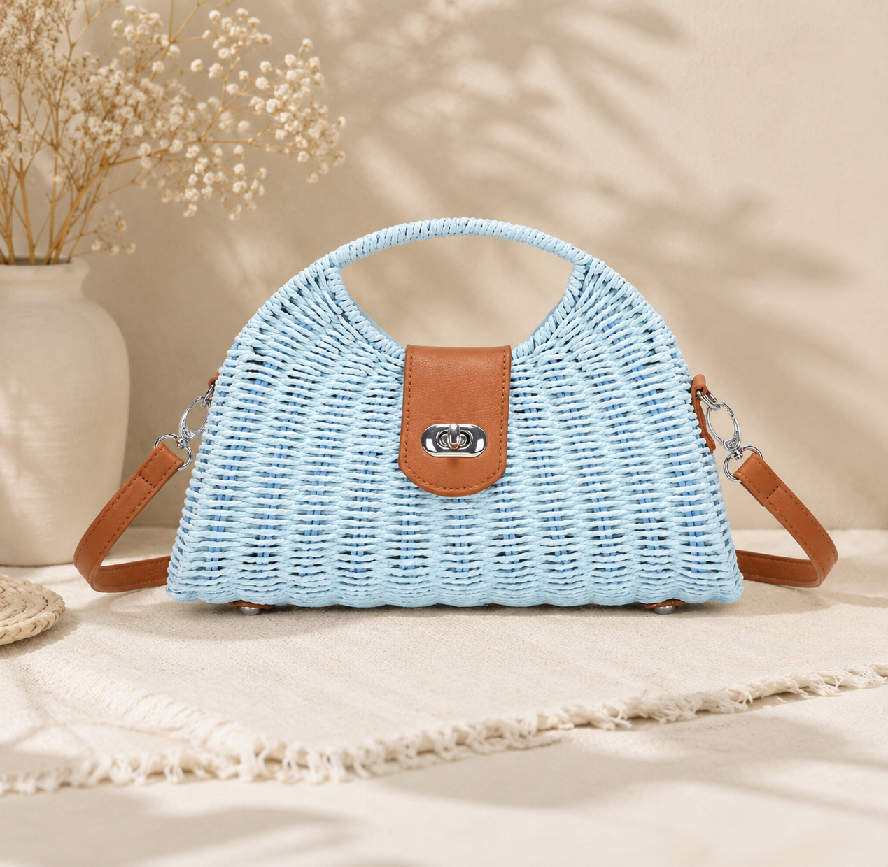 Light blue woven handbag with brown leather accents on a neutral background