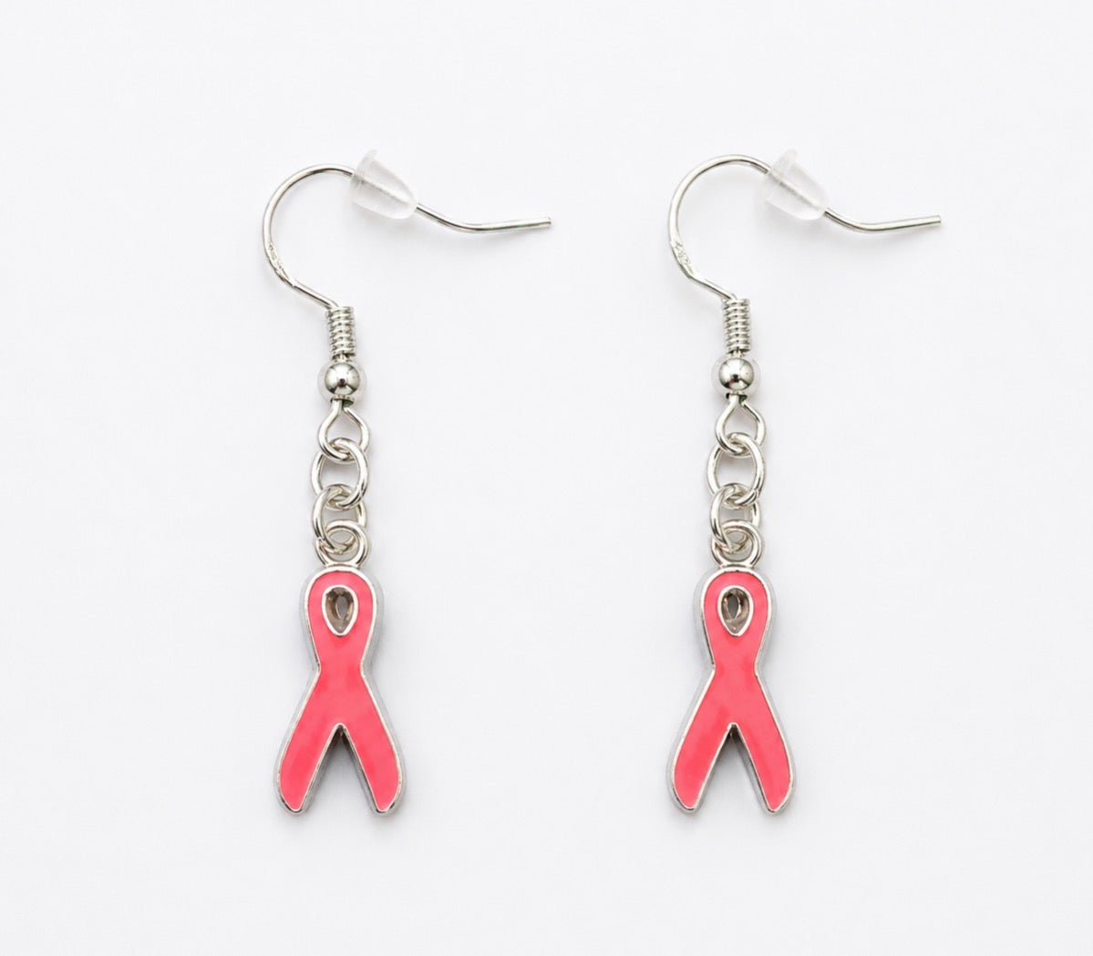 A pair of silver-toned dangle earrings with pink awareness ribbon charms, shown on a plain white background.