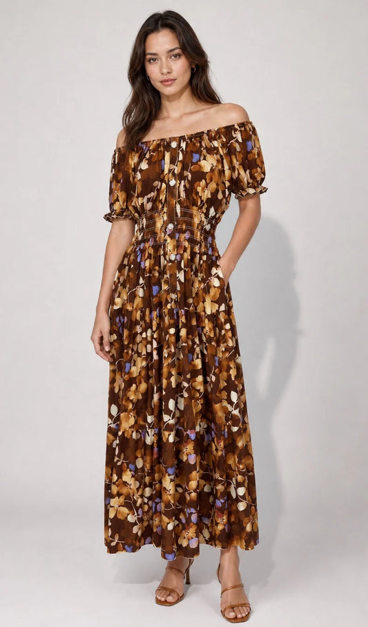 Woman wearing a floral off-shoulder dress on a white background