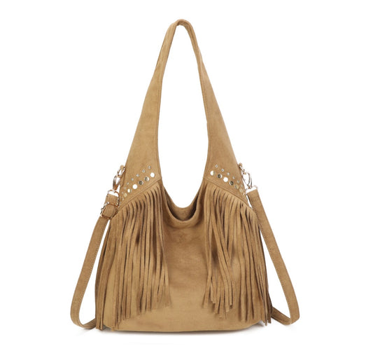 A tan suede hobo shoulder bag with long fringe detailing, silver-tone metal studs, and a matching adjustable shoulder strap, shown against a plain white background.