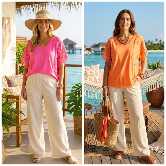 Two women in Crochet Sleeve Oversized Top, one in Orange and one in Pink with ocean views in the background