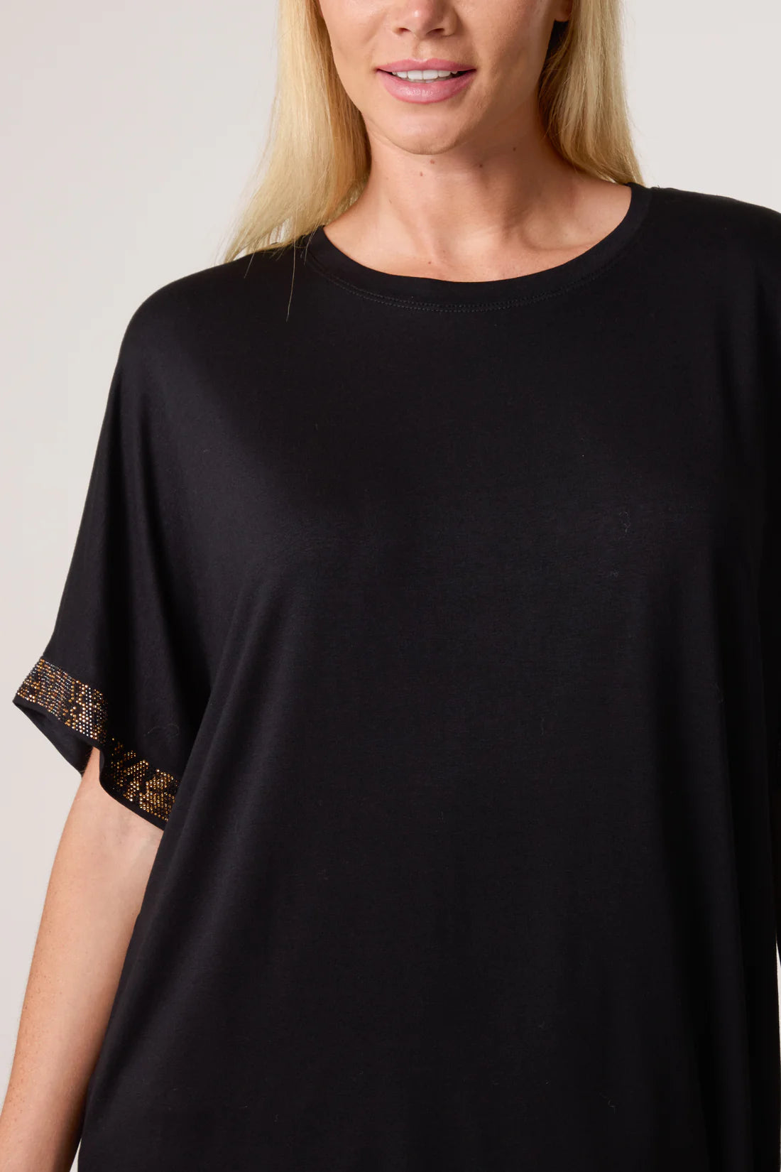 Black t-shirt with diamante sleeves worn by a person on a plain background