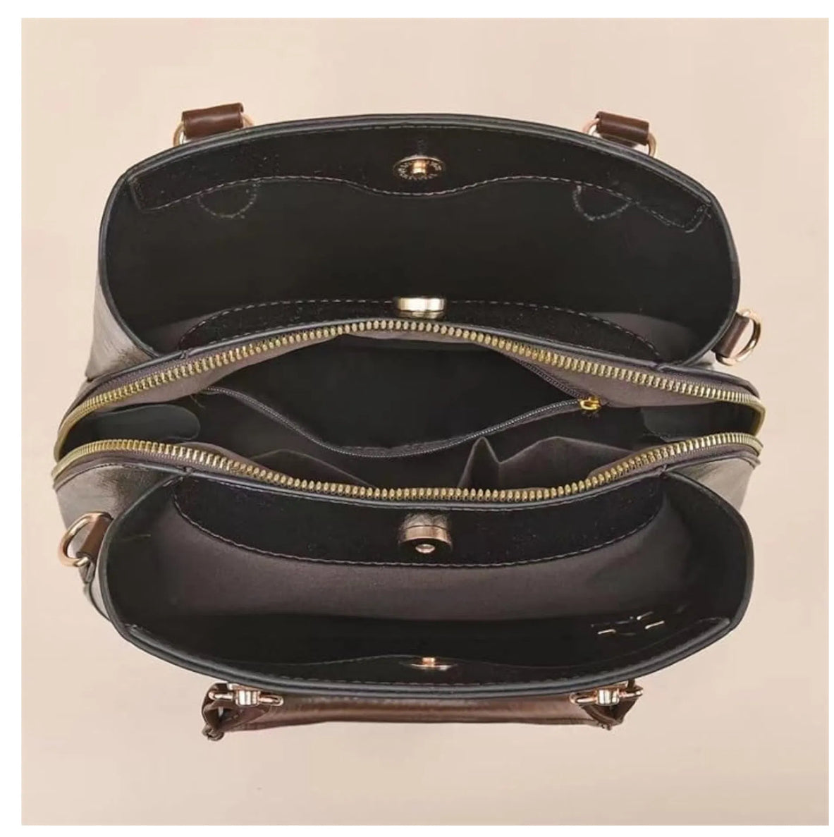 Inside of bag showing three compartments with middle zip section. 
