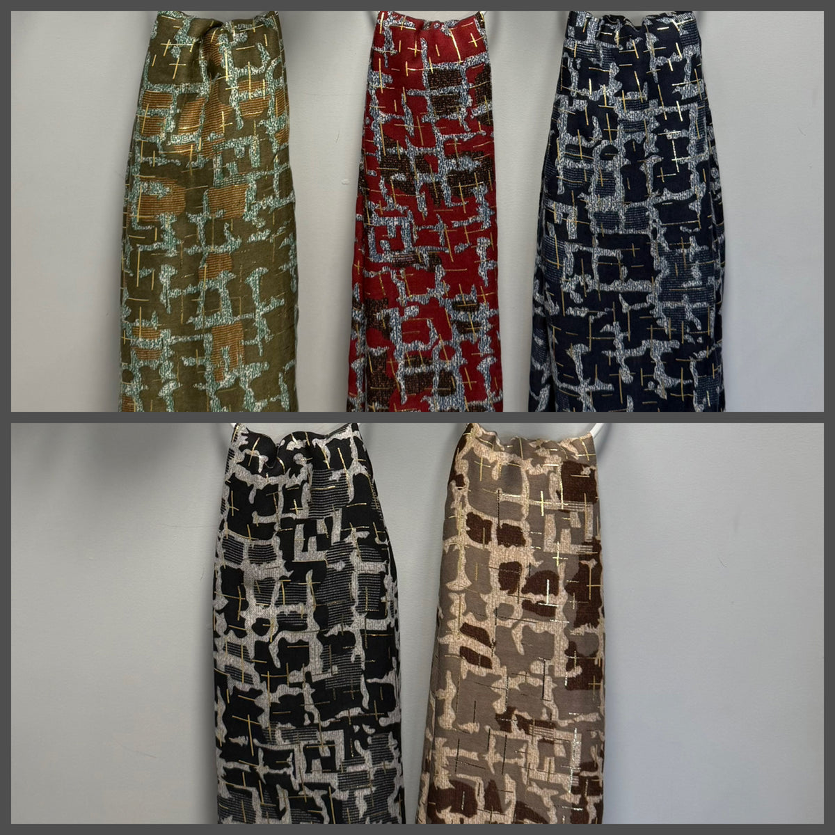 Five women's gold foil detail scarves with abstract geometric block patterns are displayed side-by-side in different colorways against a plain light gray background.