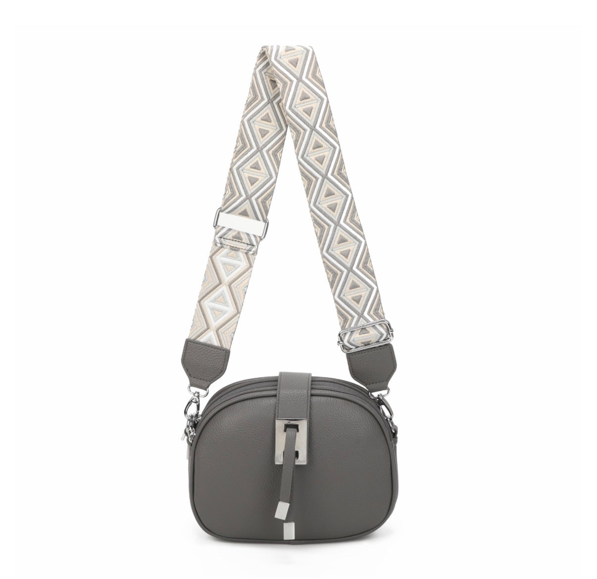 Gray handbag with a patterned strap on a white background
