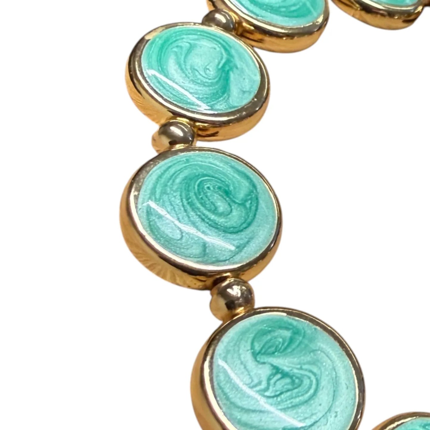 Close-up of Jess & Lou Aqua Blue Disc Pearlescent Bracelet on a white background