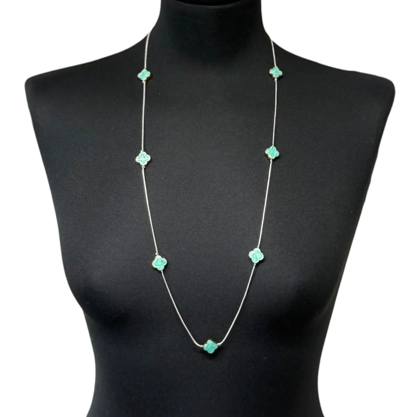 Jess & Lou Blue Clover Pearlescent Necklace on a black mannequin