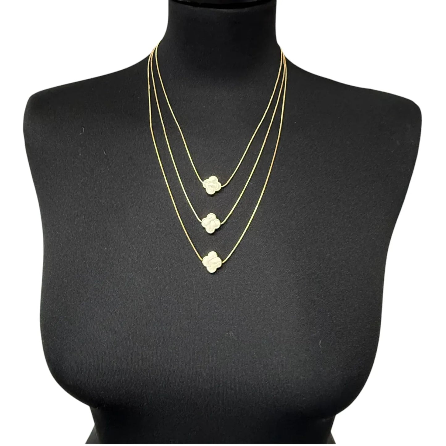 Jess & Lou White Multi-Layer Clover Pearlescent Necklace on a black mannequin bust.