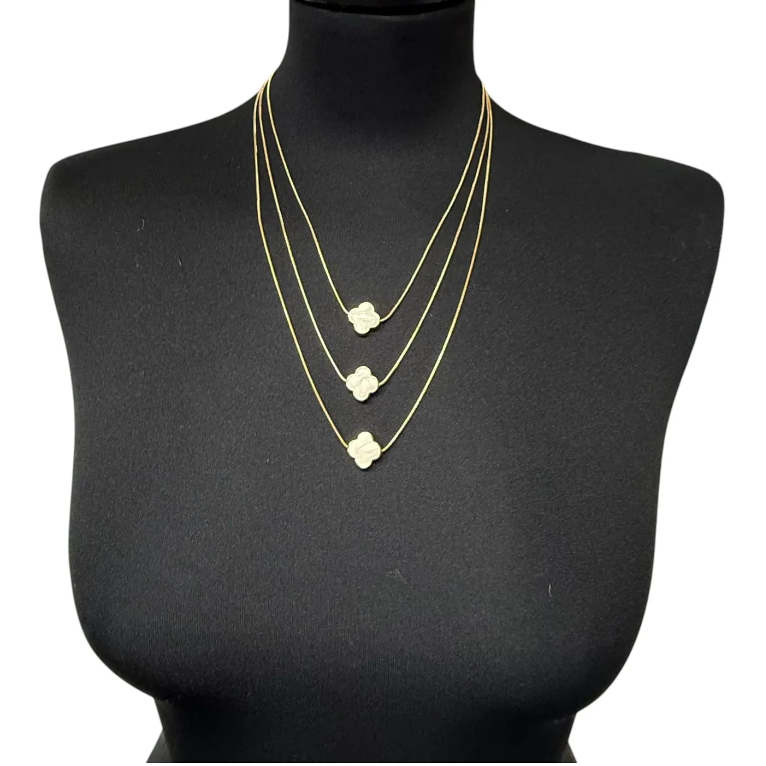 Jess & Lou White Multi-Layer Clover Pearlescent Necklace on a black mannequin bust.
