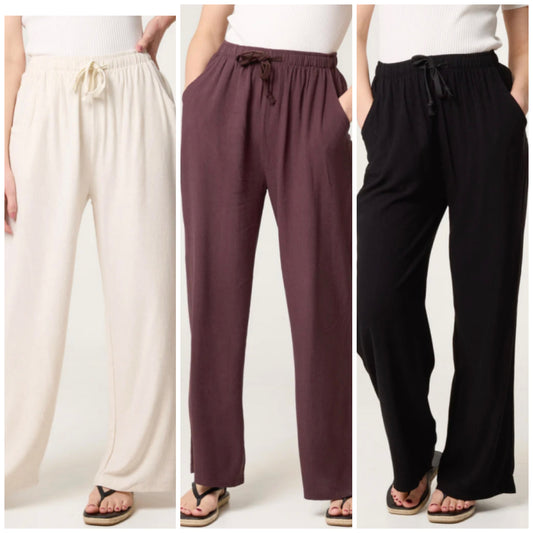 Three pairs of Linen Blend Drawstring Pocket Trousers in white, brown, and black on a white background.