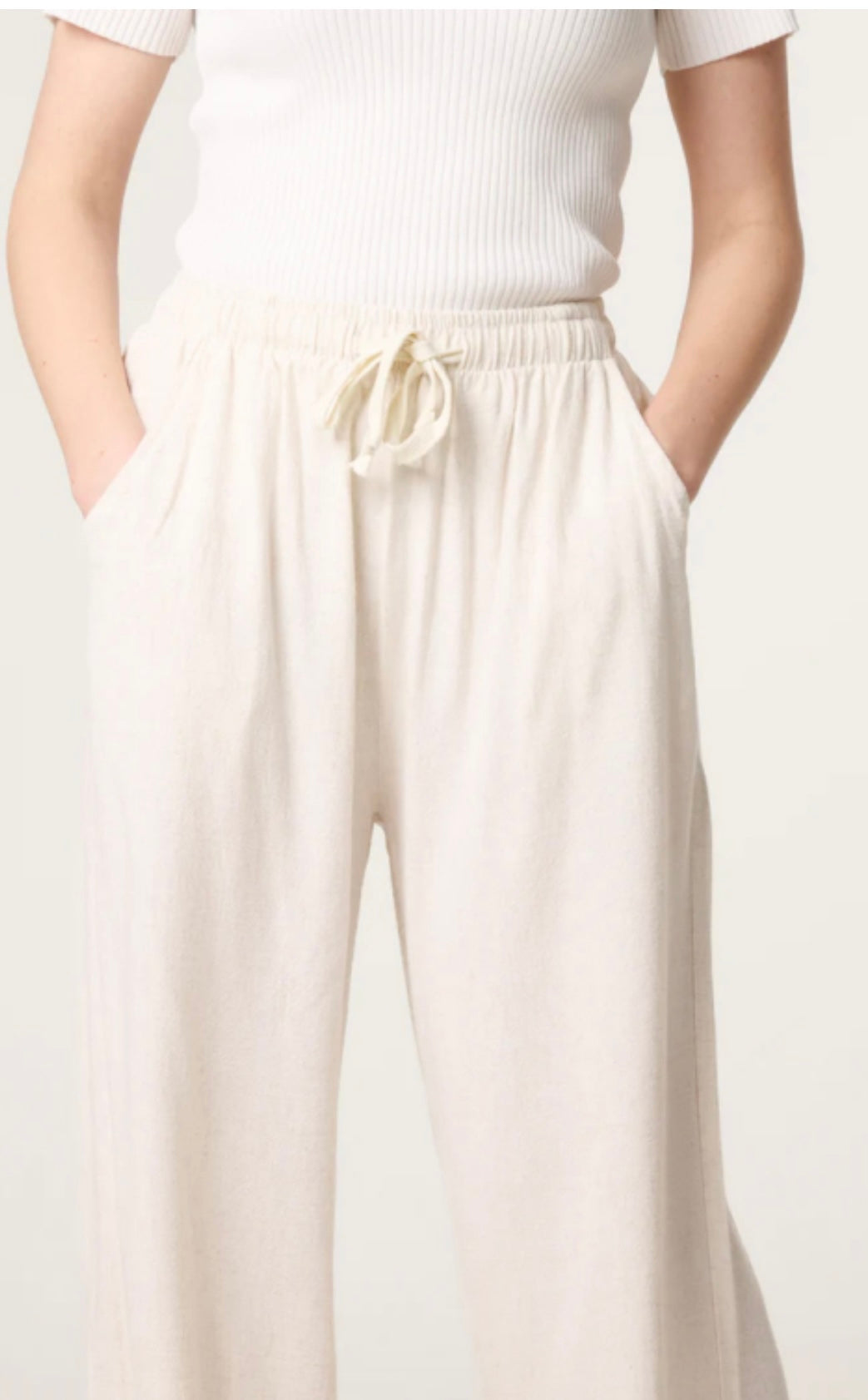 Person wearing a white top and Linen Blend Drawstring Pocket Trousers on a plain background