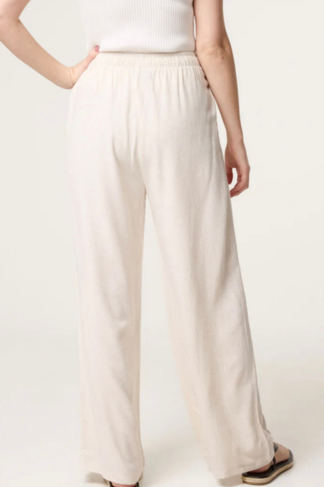 Person wearing beige Linen Blend Drawstring Pocket Trousers on a plain background