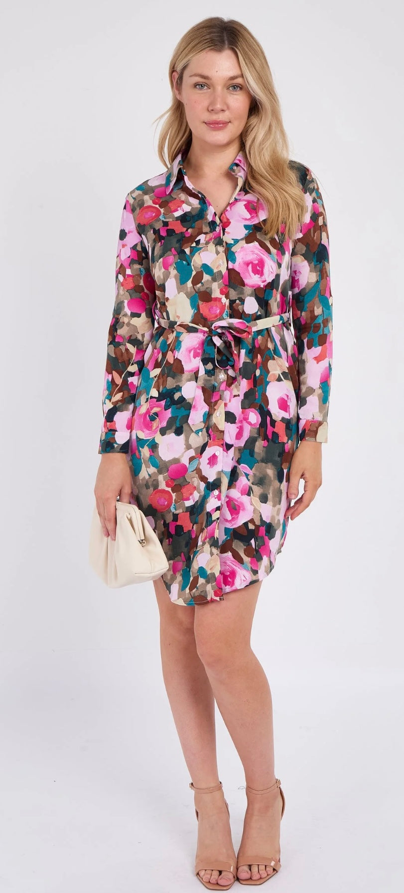 Woman wearing a colorful floral dress on a white background