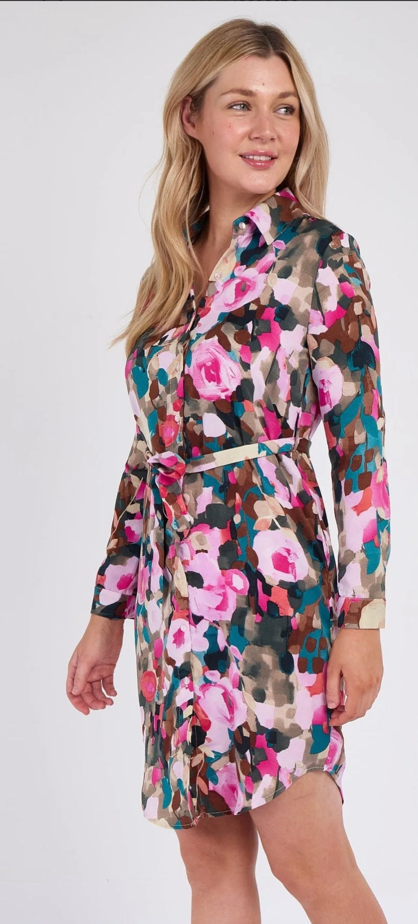 Woman wearing a floral dress with a belt on a white background