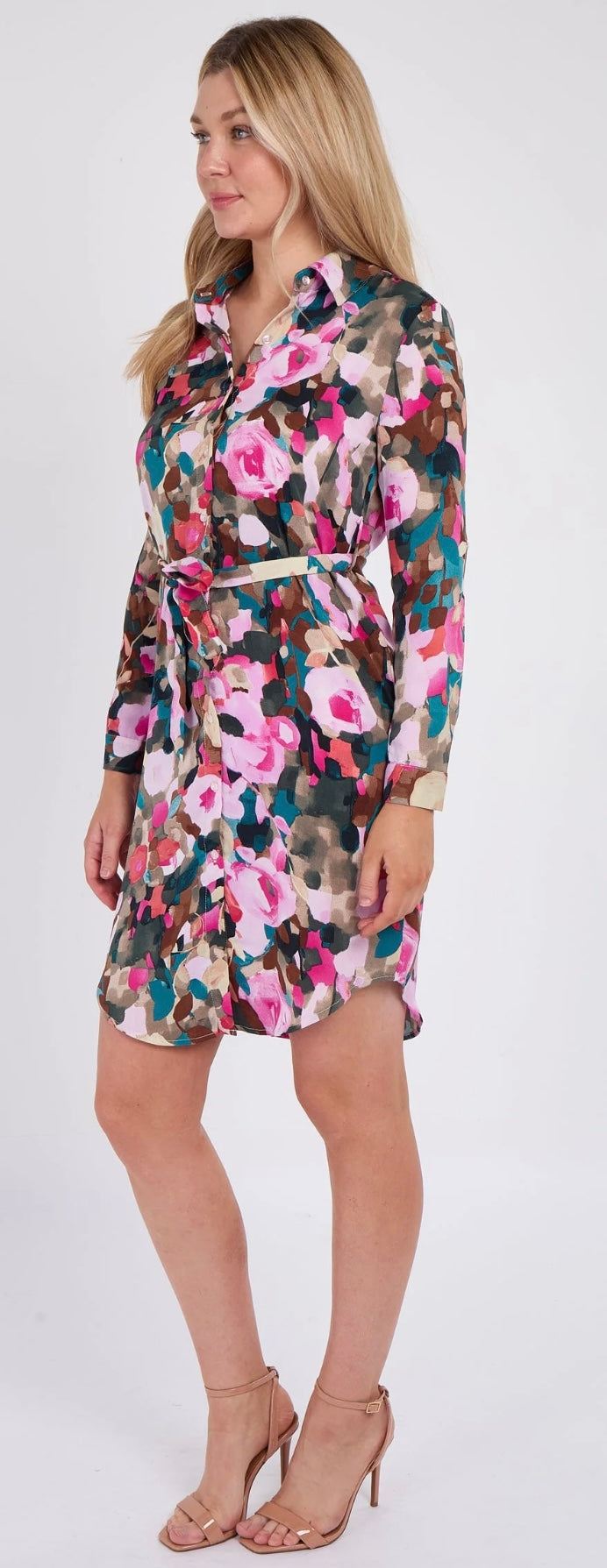 Woman wearing a colorful floral dress on a white background