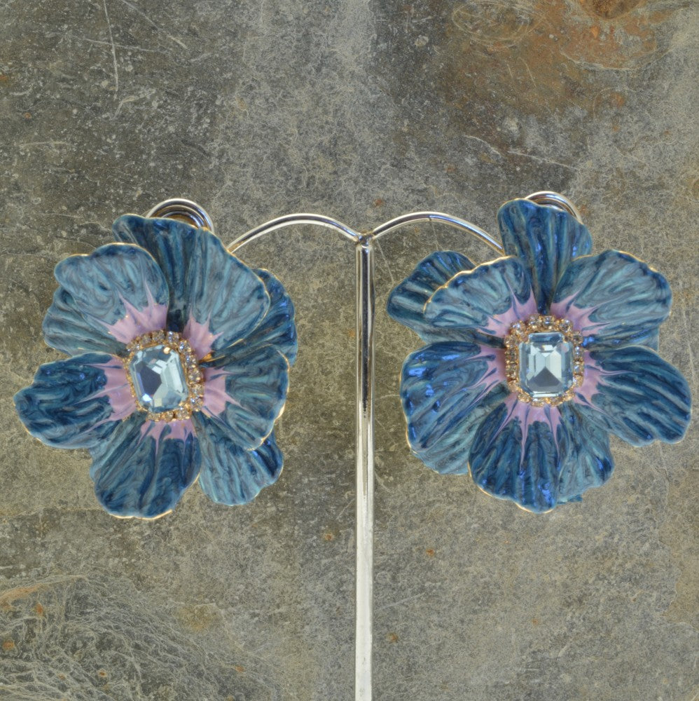 Miss Milly Blue Flower Statement Earrings On display stand with textured background 