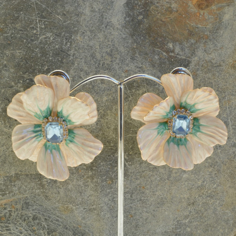 Miss Milly Cream Flower Statement Earrings On display stand and textured background 