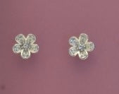 Pair of silver flower-shaped earrings on a pink background