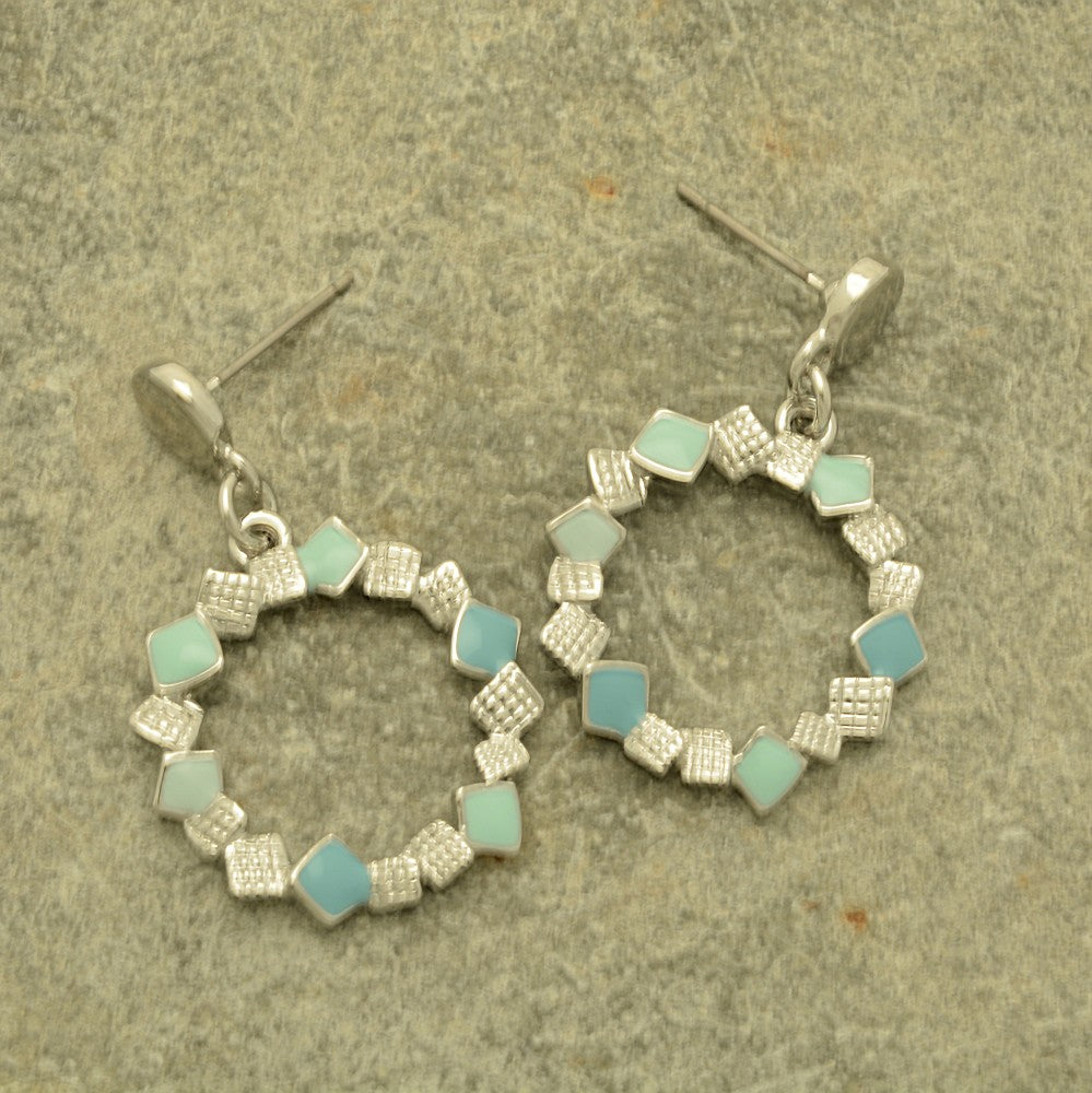Miss Milly Mint Green Confetti Earrings on a textured surface