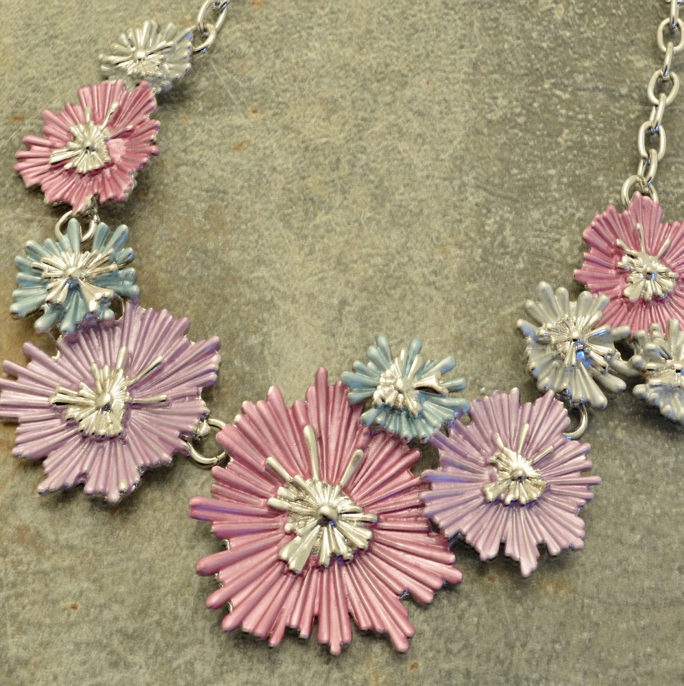 Miss Milly Multicolour Ice Flower Necklace on a textured surface