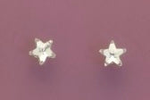 Star-shaped earrings on a purple background