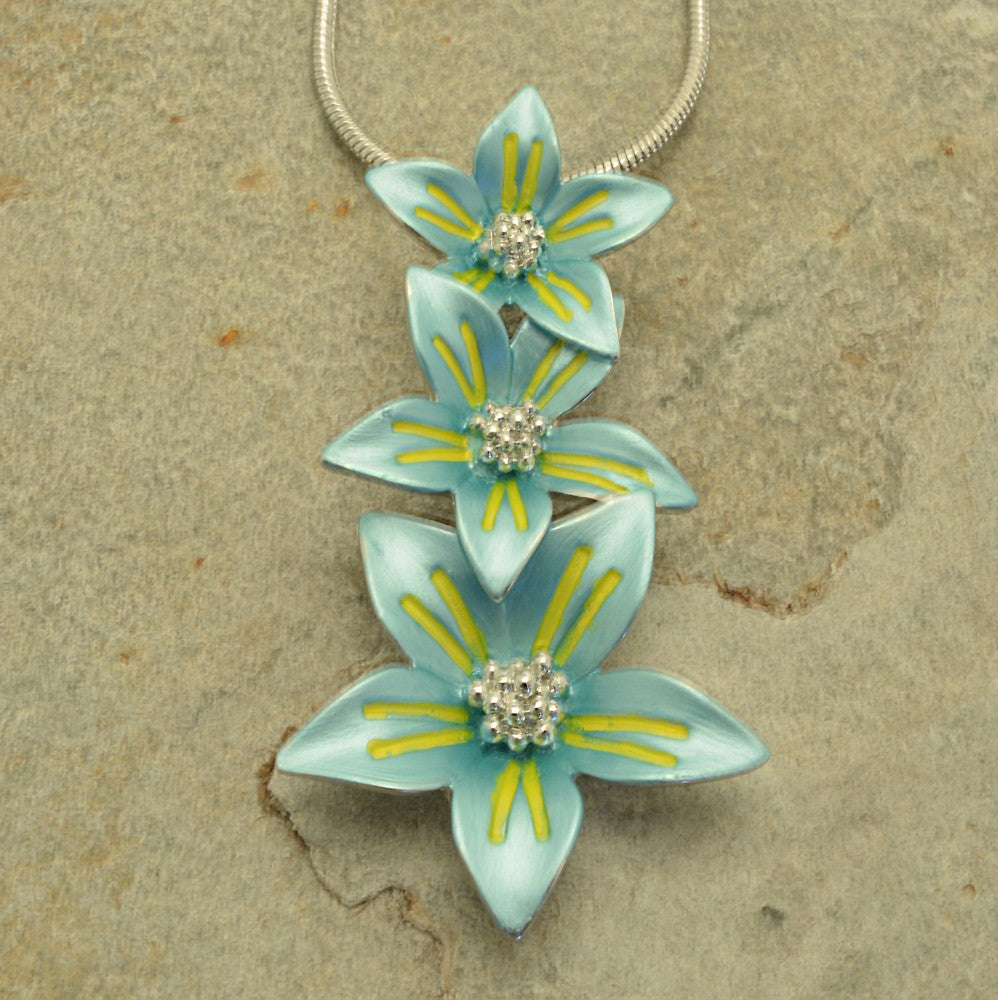 Miss Milly Turquoise Flower Trio Necklace On textured background 