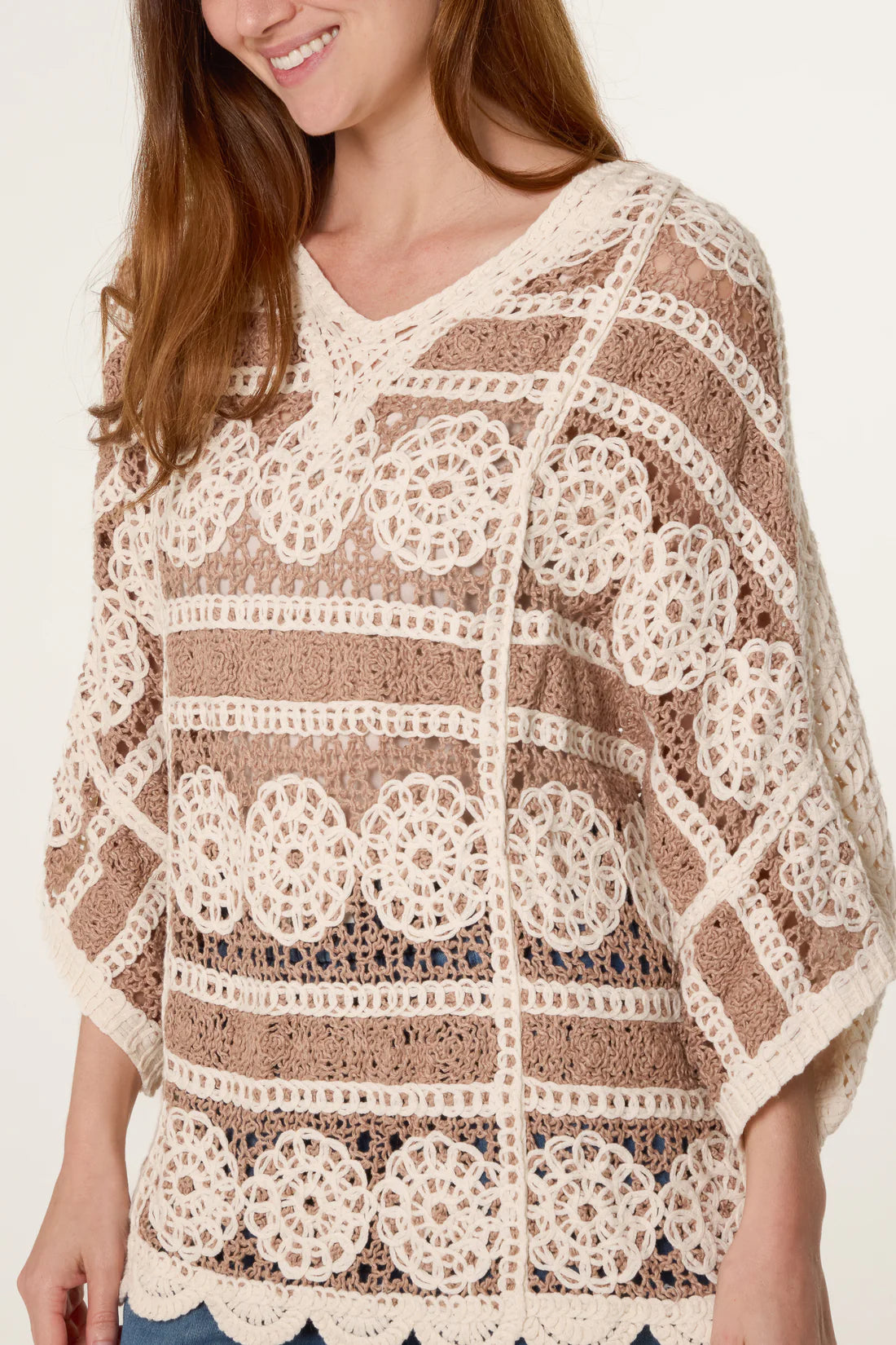 Woman wearing a Mocha and Cream Crochet Circle Scallop Edge Top on a plain background