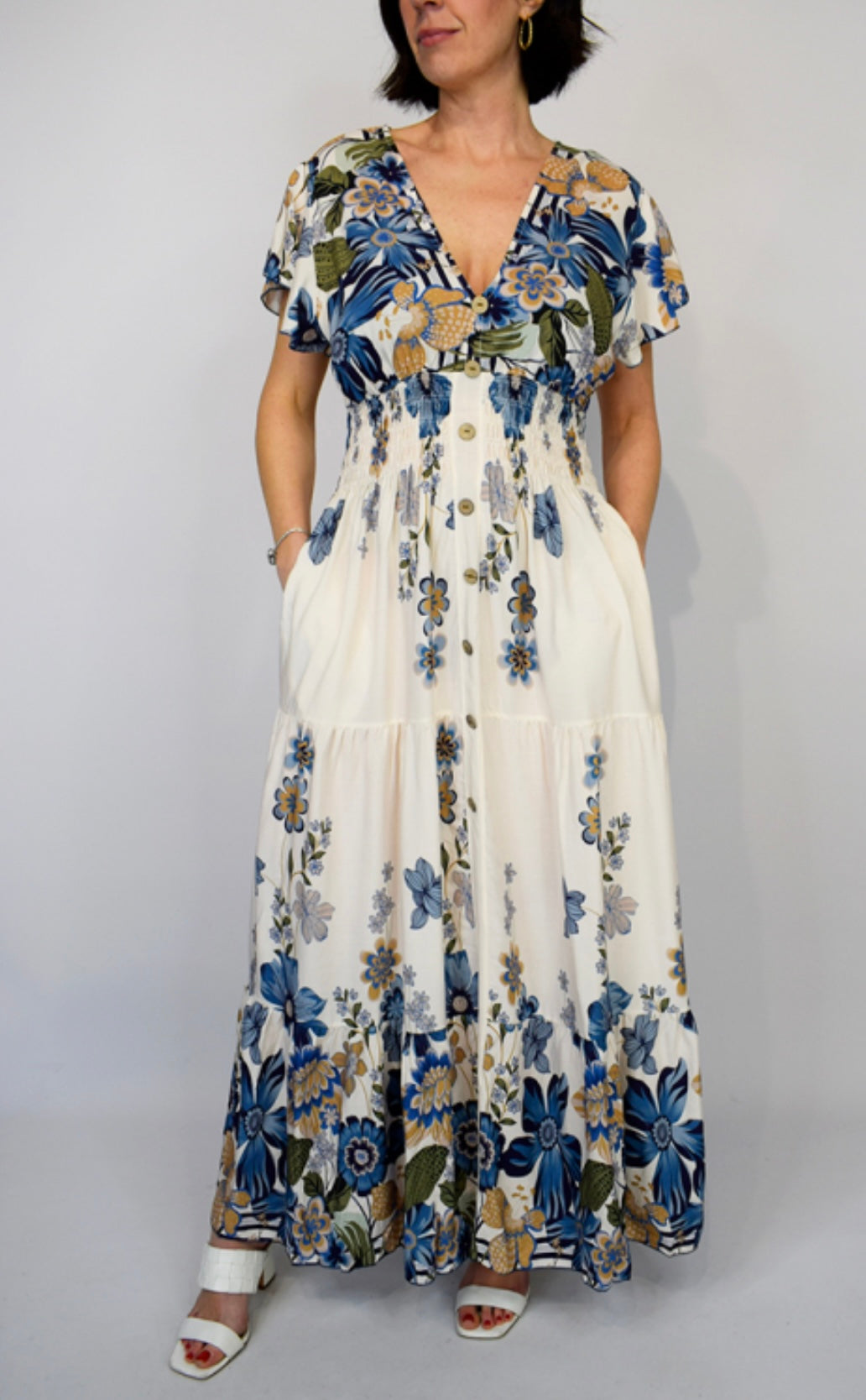 Woman wearing a Navy Bold Flower Border Button Maxi Dress with a plain background
